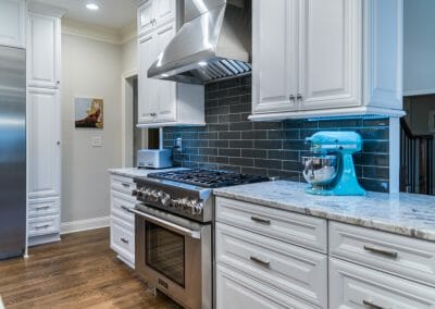 Pro-style range with fashionable gray subway tile backsplash in kitchen remodel in East Cobb