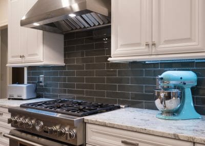 Stylish gray backsplash behind the range and vent hood in East Cobb kitchen remodeling project