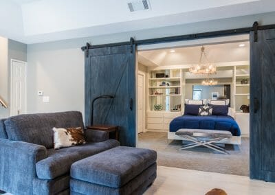 Barn doors open from the sitting room to the bedroom in the master suite remodel in Roswell