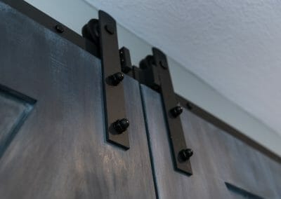 Detail of barn door hardware in master suite remodeling in Roswell