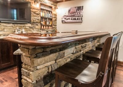 The bar and seating in the basement remodel home bar in East Cobb