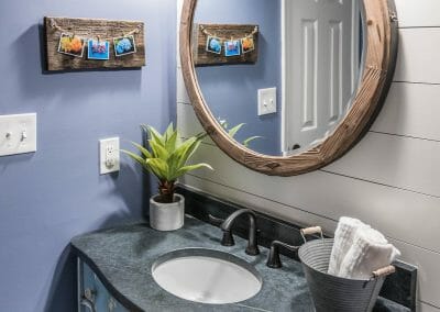New lighting, shiplap, and repurposed vanity in East Cobb powder room remodel
