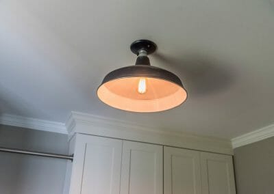 Industrial style light fixture in the East Cobb laundry room