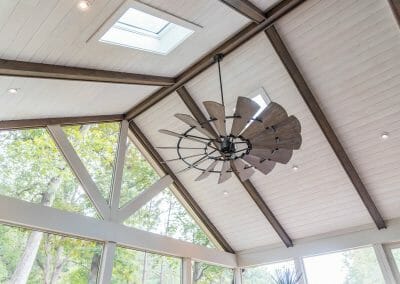 Skylights, ceiling fans, and structural beams in screened porch remodel in East Cobb