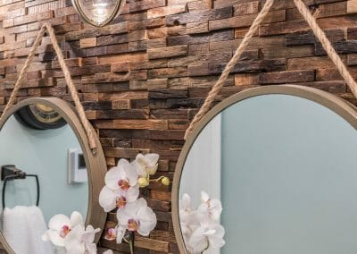 Hanging mirrors, backsplash, and nautical light fixture in the East Cobb bathroom remodel
