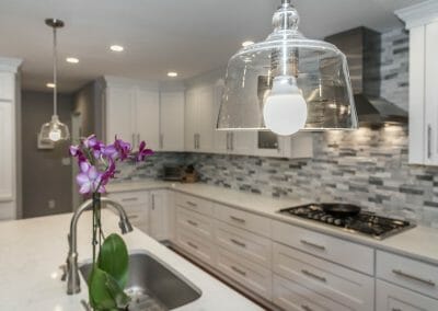 Pendants hang over the granite island in the Sandy Springs kitchen remodel