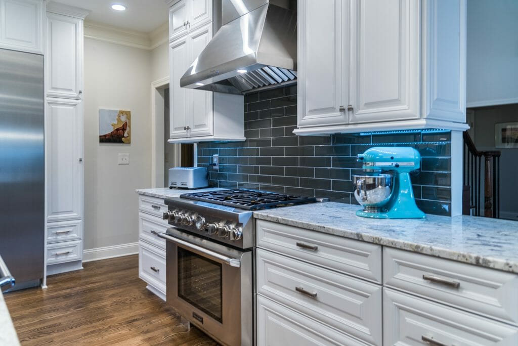 Pro-style range with fashionable gray subway tile backsplash in kitchen remodel in East Cobb