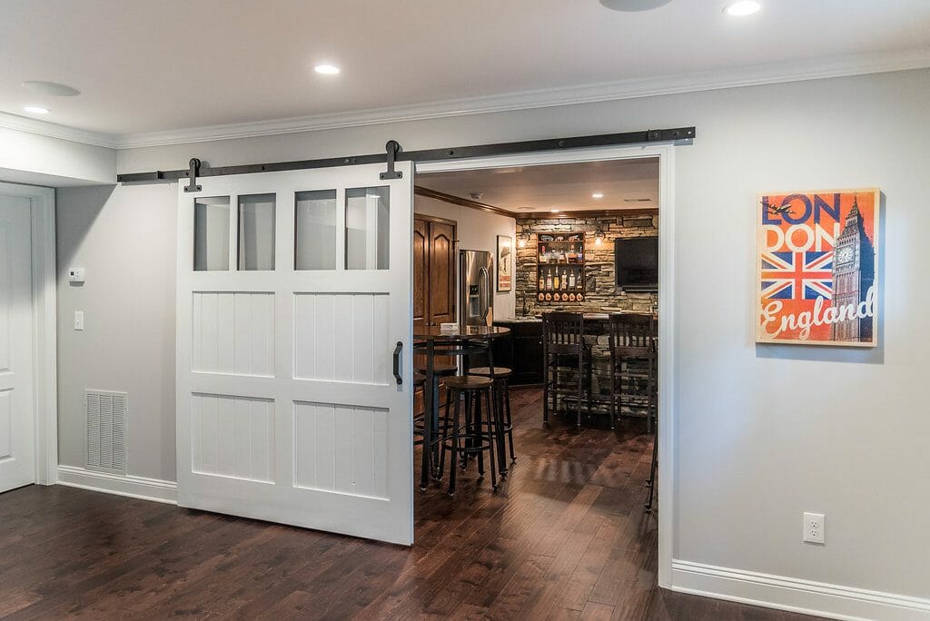 Sliding barn door between the rooms in the East Cobb basement entertainment space East Cobb