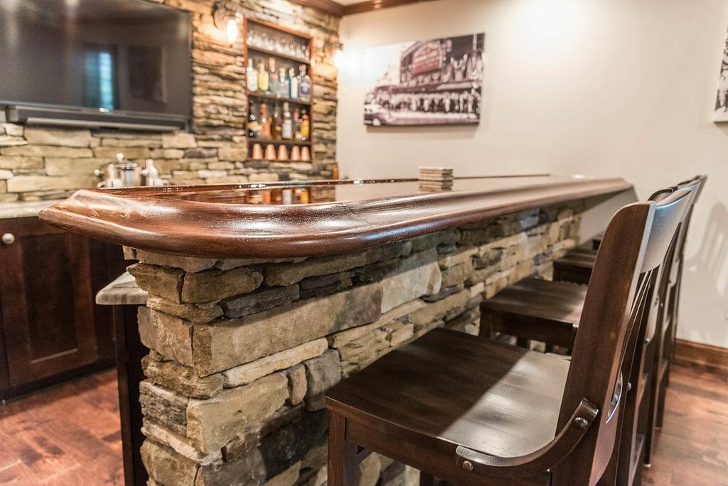 The bar and seating in the basement remodel home bar in East Cobb