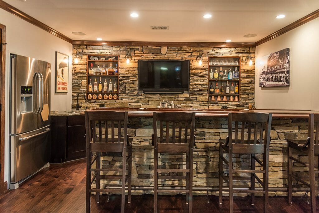 The stone home bar in the remodel in East Cobb by GreatHouse