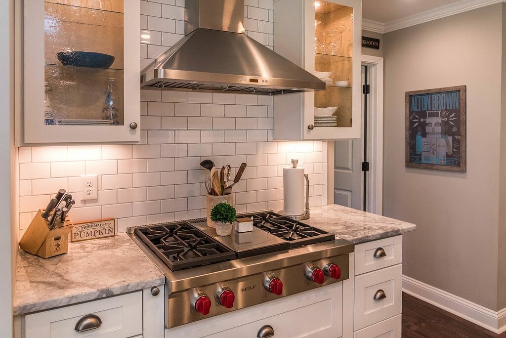 Cooktop and glass-front cabinets in East Cobb kitchen remodel