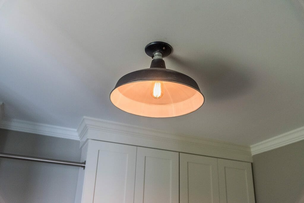 Industrial style light fixture in the East Cobb laundry room