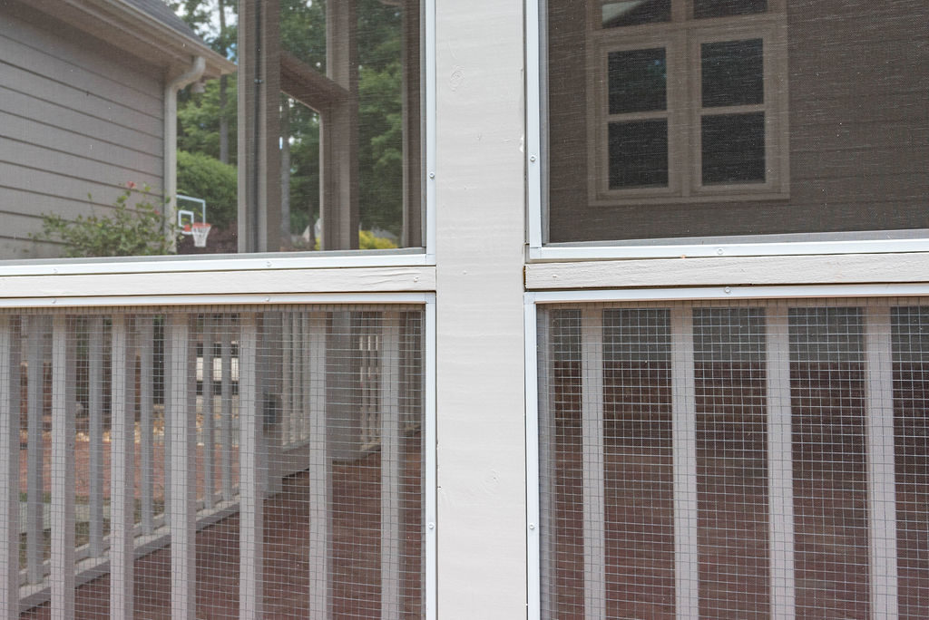 Porch renovation detail of custom screens, handrail and balusters, and hardware cloth for lower section to protect the screen from pets.