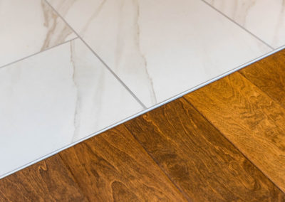 Tile and hardwood flooring transition for bathroom